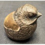 An Edwardian silver pin cushion by Sampson Mordan & Co Ltd, modelled as a bird hatching from an egg,