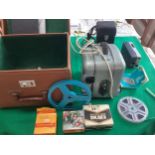 A 1960/70s projector in a box with a broken lock and a cased Kodak Instamatic M4 movie camera with