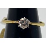 An 18ct yellow gold solitaire diamond ring, the round brilliant cut diamond being K in colour, VS1