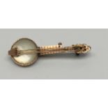 A 9ct gold brooch modelled as a banjo with mother of pearl body, 3.7cm, gross weight approximately