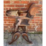 A metamorphic child's high / low chair with brown leather back and sides with studded detail,