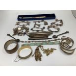 A small collection of assorted silver items comprising various charm bracelets and bangles,