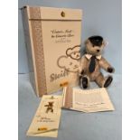 A Steiff 'Captain Mach the Concorde Bear' collectors bear, with cap, collar and blue tie, grey
