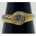 An 18ct yellow gold diamond ring, set with a round brilliant cut diamond to the centre, and three