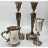 A small collection of silver items comprising a pair of loaded silver candlesticks, 26cm tall, a