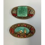 Two 1930s gilt metal Chinese style shaped oval brooches probably by Max Neiger (brothers), one