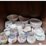 A collection of 19 assorted items of Poole Pottery, comprising vases, bowls and dishes etc.