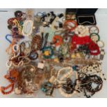 A large quantity of costume jewellery including some silver items, amber coloured beads,