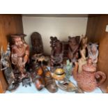 A collection of assorted Oriental and Balinese carved wooden figures and masks, together with