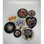 Eight various modern Moorcroft pottery pin dishes decorated with flowers including two examples by