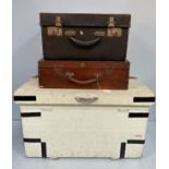 A canvas covered trunk with metal bound sides and handles to each end, together with a black leather