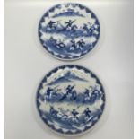 A pair of Chinese porcelain dishes, blue painted underglaze with figural scenes of fighting warriors