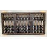 A vintage Chinese abacus (Suanyan) with thirteen rows of black counting beads, in black painted