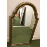 A gilt-framed, arch top bevelled mirror, 105cm tall