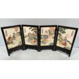 A Chinese porcelain four-fold table screen, each panel decorated in polychrome enamels with