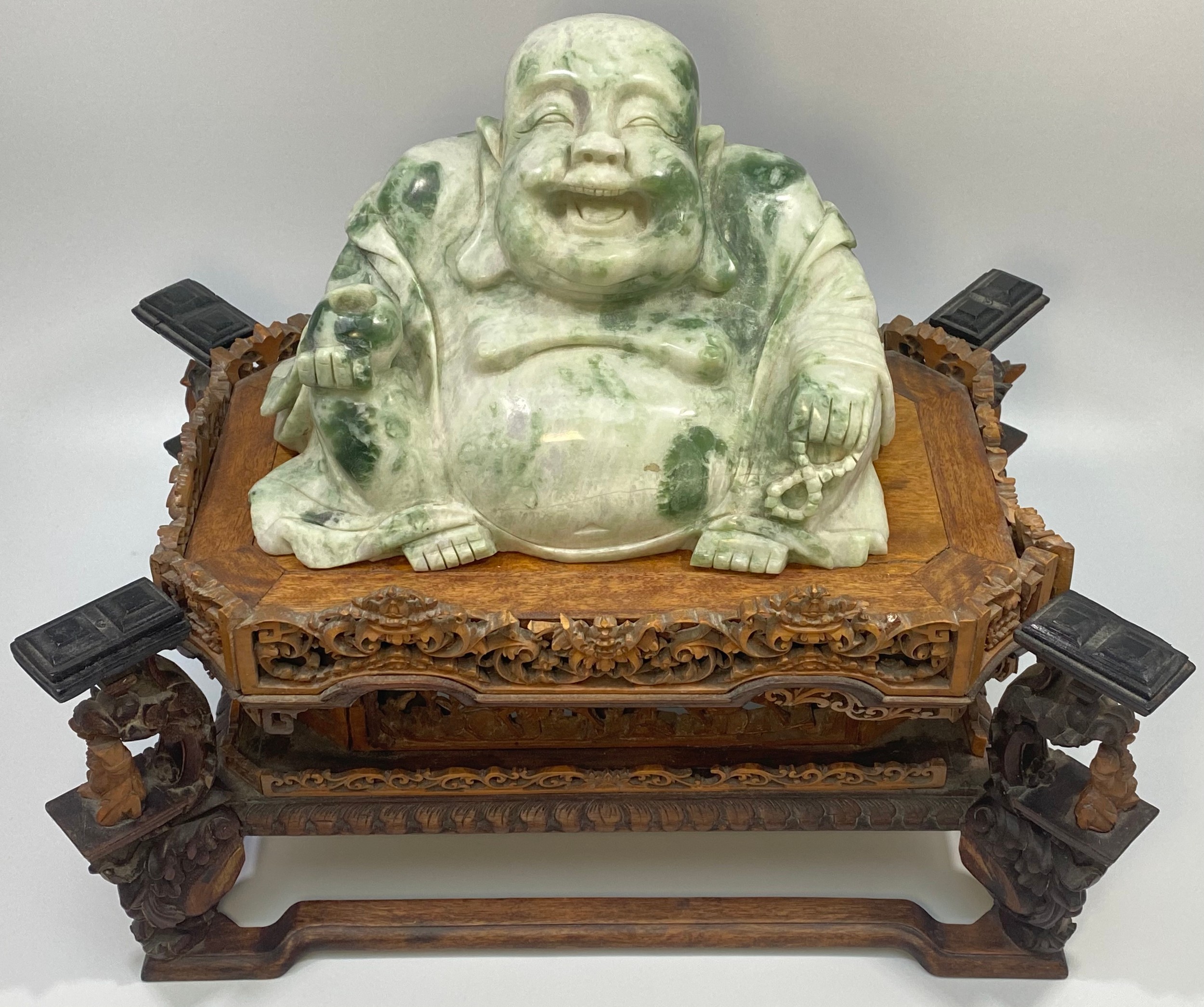 A carved jadeite figure of the seated happy buddha, 14cm high, raised on a finely carved boxwood and