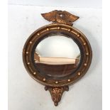 A Regency style gilt circular convex mirror with beaded border and eagle finial, 65 x 43cm