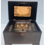 A Victorian inlaid rosewood Swiss cylinder music box playing eight airs, listed on underside of lid,