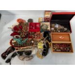 A box of mixed costume jewellery including necklaces, brooches, earrings, bracelets and watches