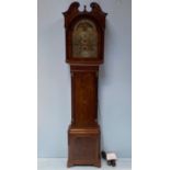 An 18th century longcase clock with swan neck pediment and arched glazed door enclosing moon phase