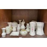 A collection of 19 assorted Belleek pottery items comprising various vases, jugs, bowls and dishes
