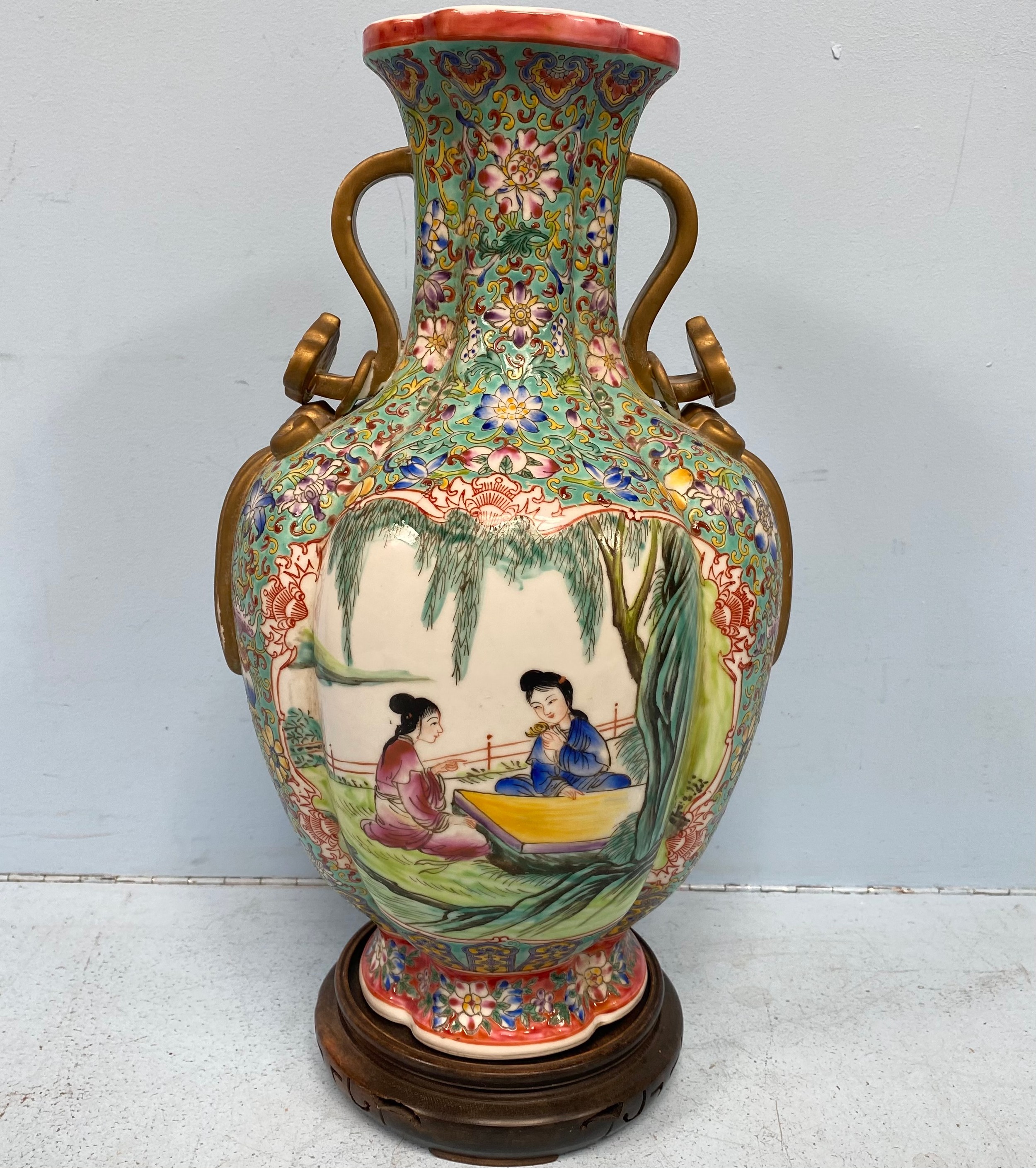 A Chinese porcelain vase of baluster form and lotus section, incised and decorated in polychrome