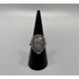 An 18ct white gold diamond dress ring, set with round brilliant and baguette cut diamond in a pear
