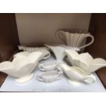 A pair of matte white glazed The Fulham Pottery vases, of flared trefoil form, raised on oval bases,