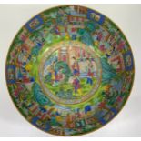 A Chinese porcelain bowl, Canton decorated in polychrome enamels with female figures in garden