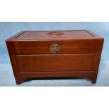 A Chinese camphor lined chest / blanket box, the cover carved with central auspicious symbol, raised