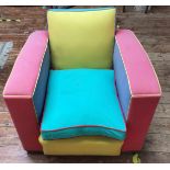 An early 20th century club chair, re-upholstered in candy-rock coloured panels