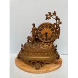 A German spelter clock, the circular dial with Roman numerals denoting hours, on naturalistic base