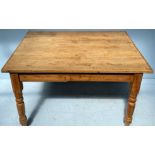 A Victorian stripped pine dining table, of rectangular form, with single frieze drawer, raised on