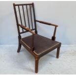 A 19th century ebonised beech bobbin-turned armchair, with stuffed fabric upholstered seat, 99cm