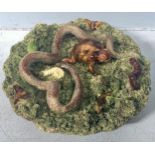 A 19th century Portuguese Palissy style Majolica dish, decorated in relief with snakes, a lizard,