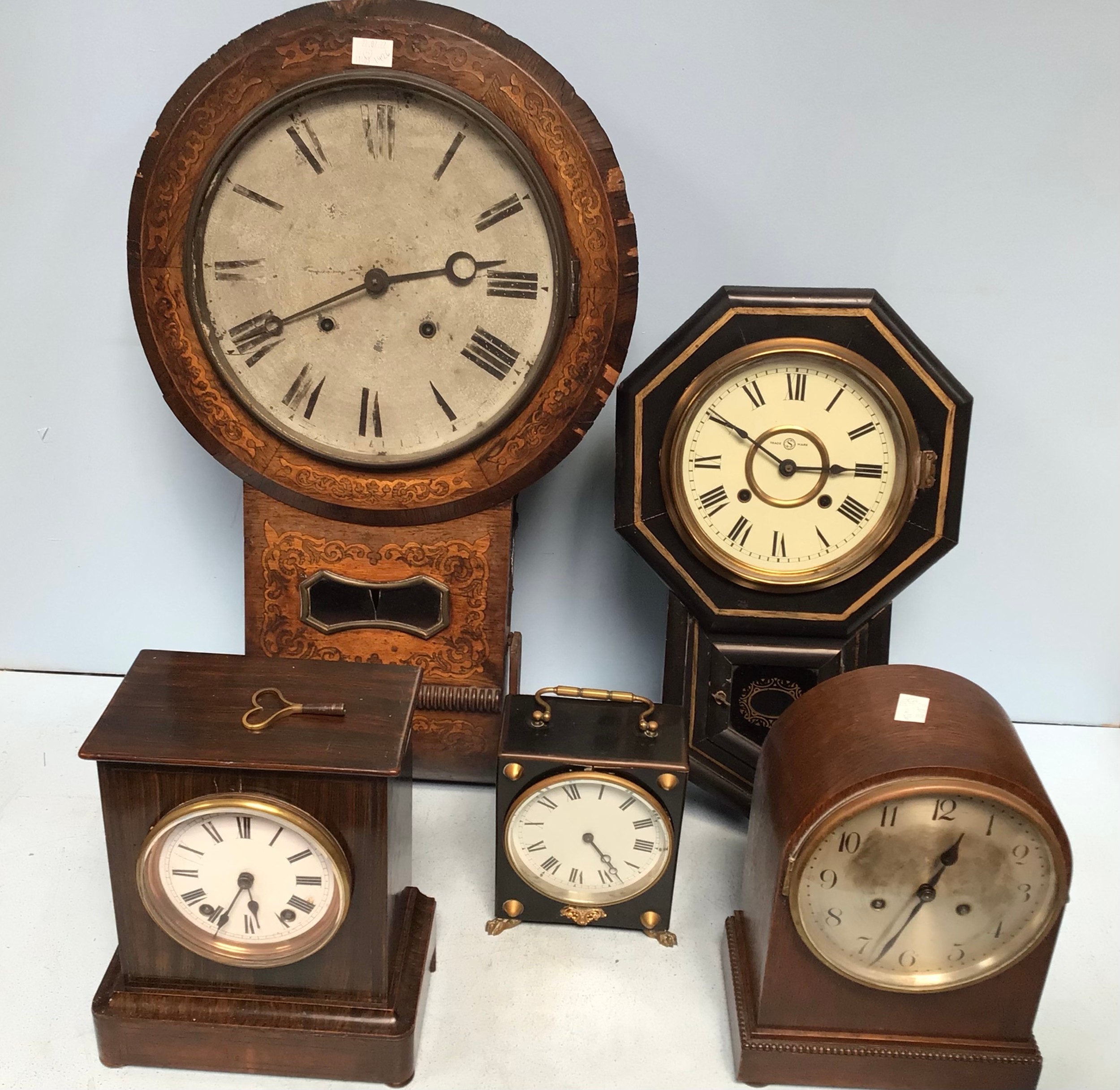 A drop-dial wall clock together with four other various clocks including a W&H Sch German mantel