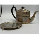 A Georgian silver teapot and stand by John Emes, with floral decoration and ebonised handle and