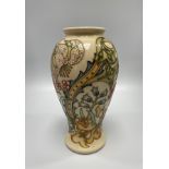 A Moorcroft pottery vase in the Golden Lily pattern to ivory ground, designed by Sally Tuffin, of