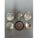 A 1885 United States One Dollar (VF+), together with 1991, 1993, and 1997 Silver Liberty Dollars,