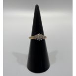 A 9ct yellow gold dress ring, set with small round brilliant cut diamonds, in a claw setting,