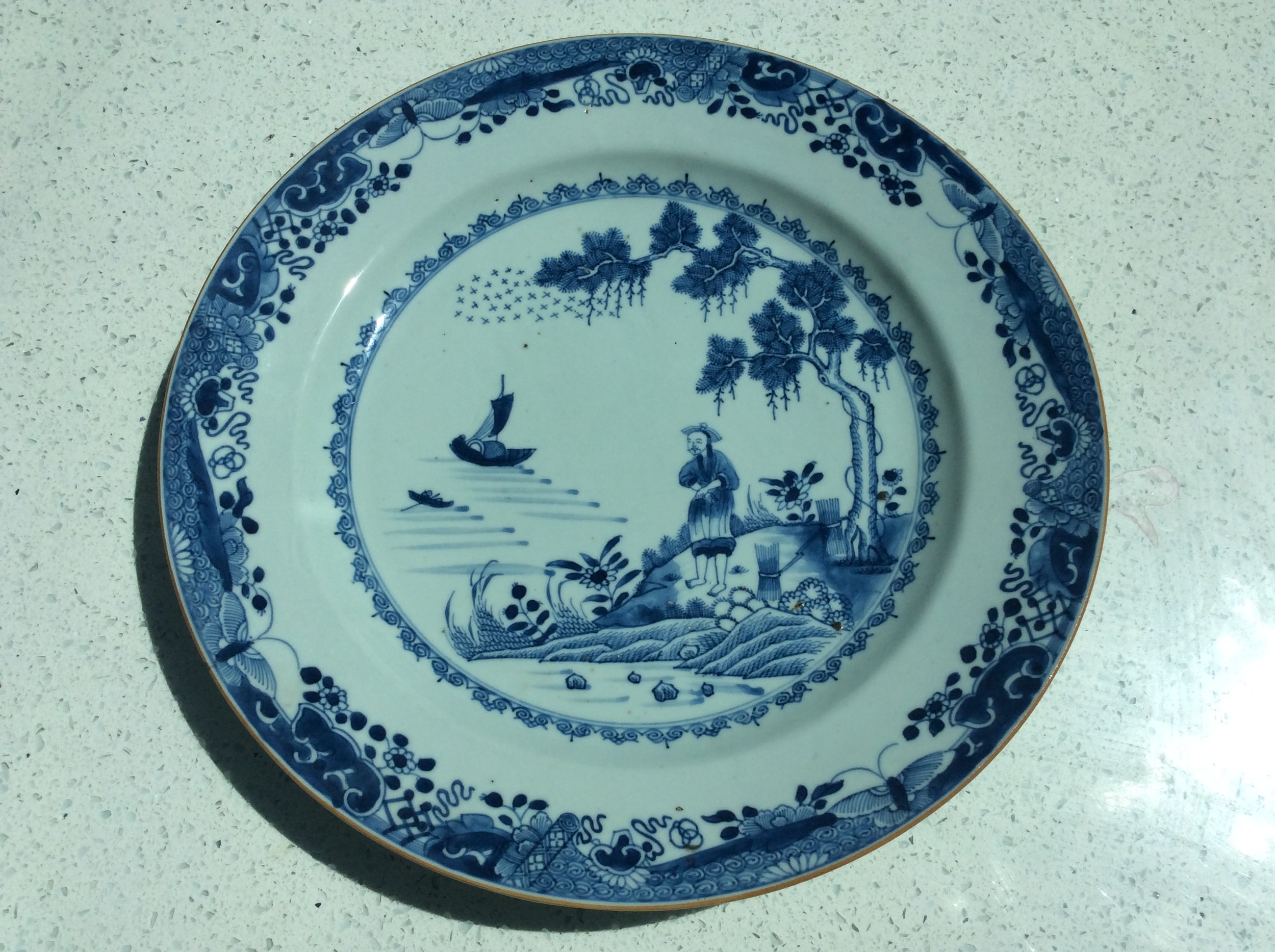 A Chinese Qianlong period porcelain charger, painted in underglaze blue with a figures on an