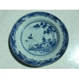 A Chinese Qianlong period porcelain charger, painted in underglaze blue with a figures on an