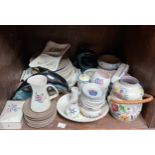 A collection of approximately 45 pieces of assorted Poole Pottery items, including plates, dolphin