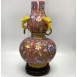 A Chinese porcelain vase of double gourd form with three animal mask and ring handles, incised and
