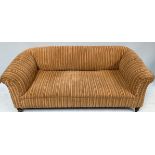 A sofa upholstered in stripy beige upholstery