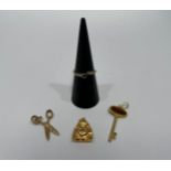 A 14K Buddha charm and 14K and tiger's eye key charm, 2.8g, together with a 9ct gold scissors charm,
