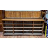 A very large oak haberdashery unit comprising top half with mirrored back and lower half with four