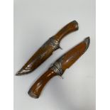 A pair of knives with 5.25" Damascus blades, metal-mounted wooden grips and sheaths