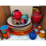 A collection of assorted Poole Pottery items comprising various vases, one with cover, a number of