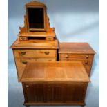 A pine dressing table with mirrored back above a chest of three graduated long drawers, raised on